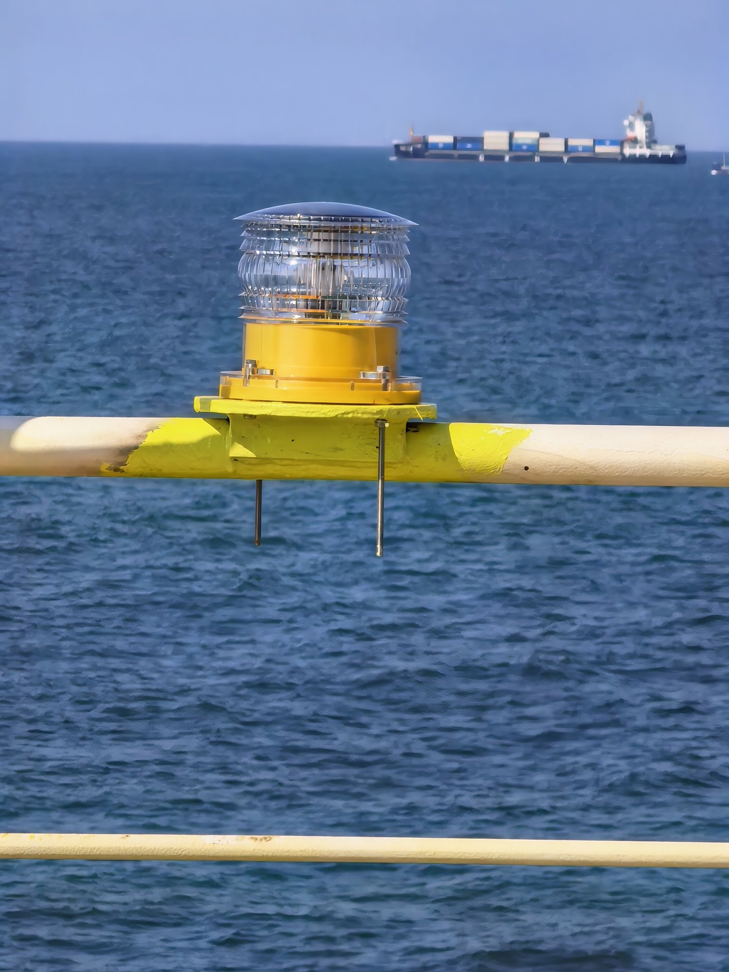 Yellow DWS303 solar marine lantern mounted on a buoy at sea